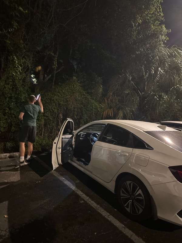 Man observed near white car at university campus nighttime