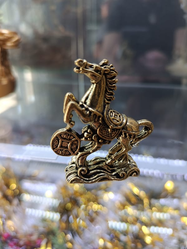 Golden horse and dragon figurines photographed in Mykolaiv