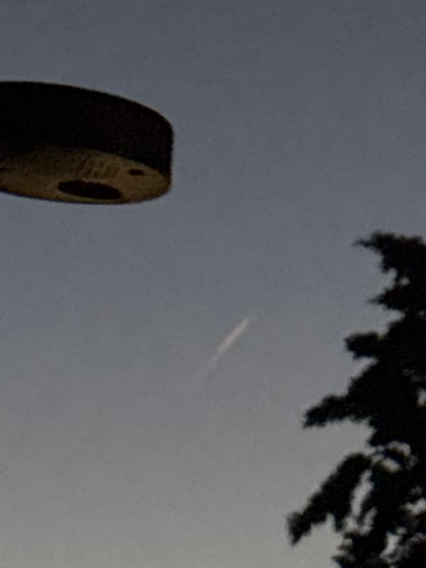 Light streak crosses twilight sky over Vicenza neighborhood