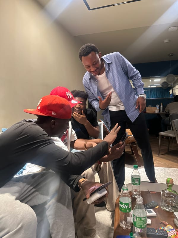 Friends gather for drinks and music in Abuja living room