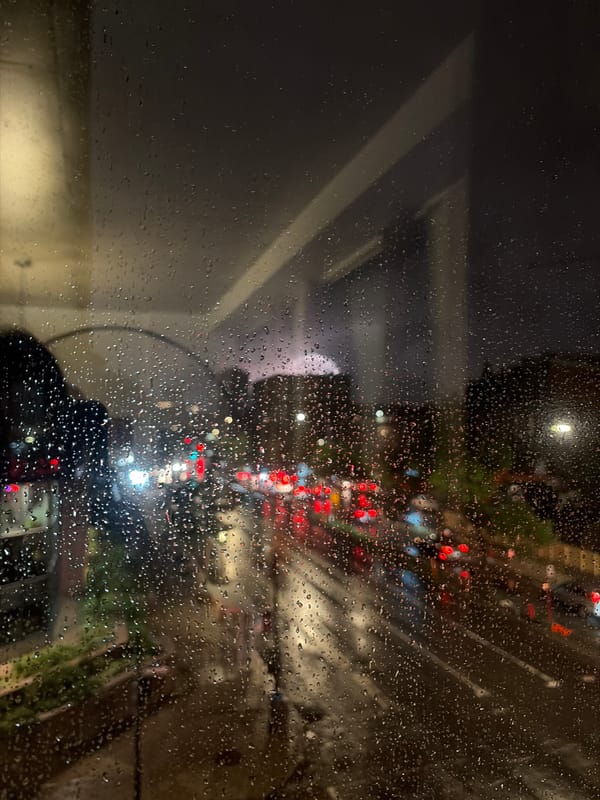 Montreal city street at night, seen through a rain-covered window