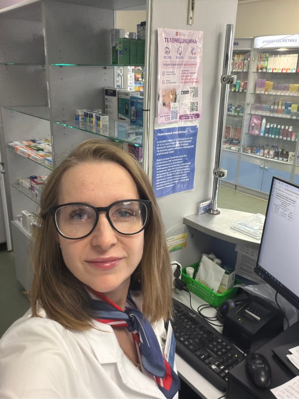 Woman takes selfie in Russian pharmacy workspace