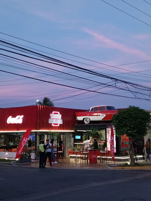 Dramatic sunset paints Pampatar Venezuela streets in pink purple hues