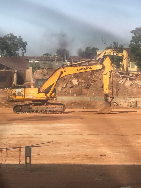 Stadium construction underway in Jos, Nigeria with heavy machinery