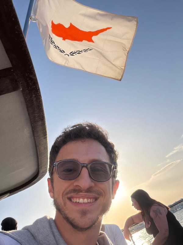 Man takes selfie near Cyprus flag in Larnaca waterfront