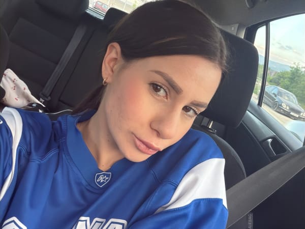 Woman in sports jersey sits in car in Plovdiv