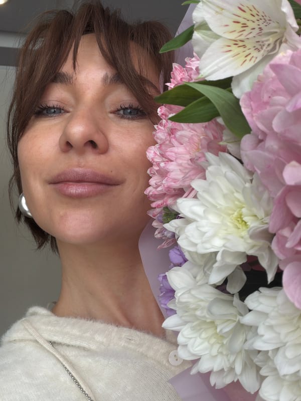 Woman photographed with flower bouquet in Ust-Ilimsk, Russia