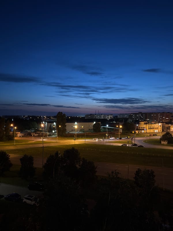 Dusk hangout in a Tolyatti apartment, city lights outside