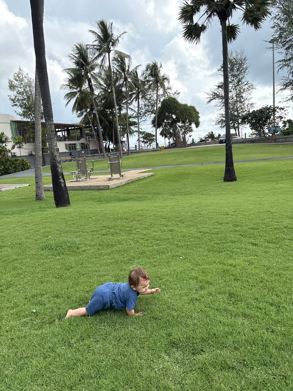 Lazy morning at a Karon park, baby on the lawn