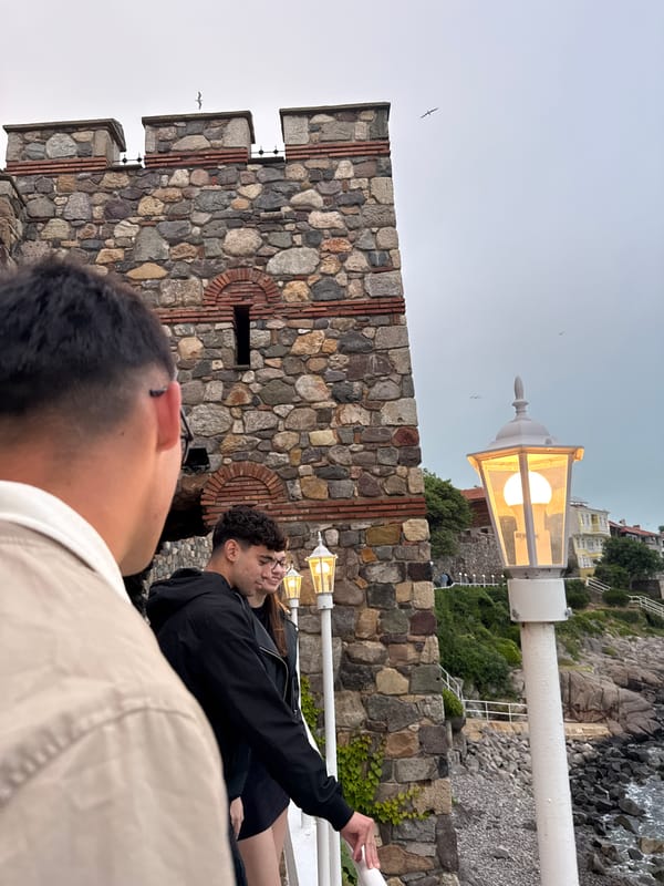 Tourists explore historic Sozopol coastline under overcast skies