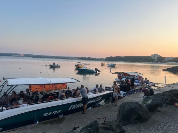 Dusk at Primorsko's marina, boats docked and sea taxi active