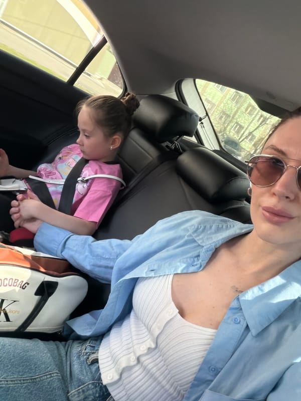 Woman takes car selfie with child in Perm, Russia