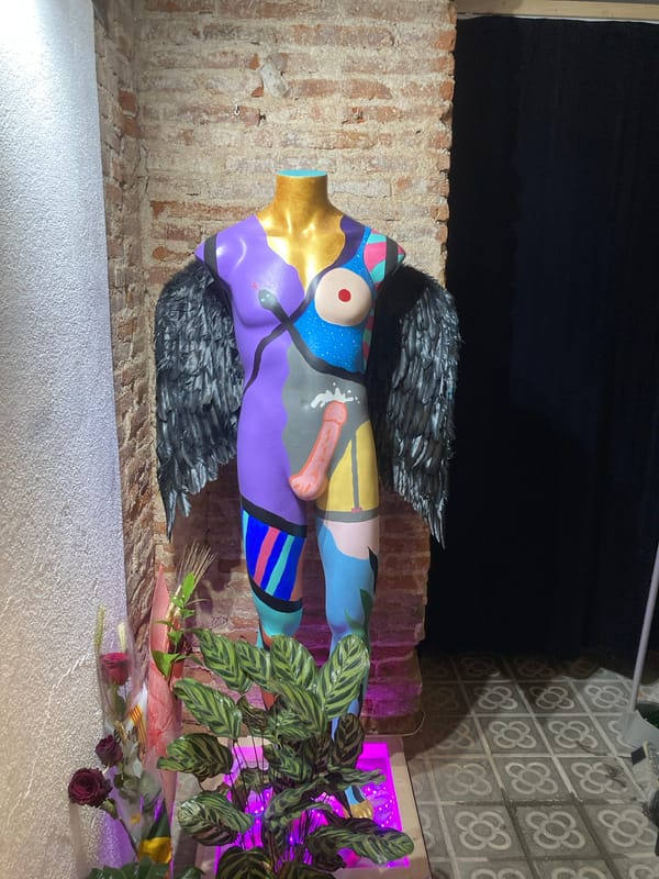Artistic mannequin with abstract designs spotted in dimly lit area