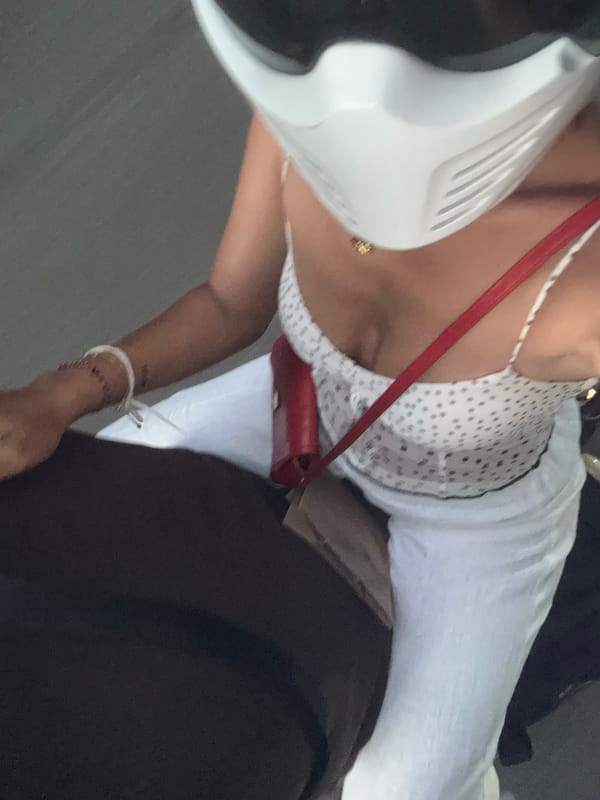 Motorcycle ride down a tree-lined road in Ubud