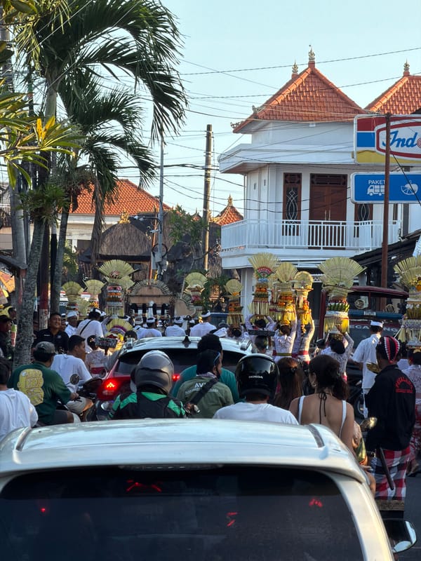 Traditional Balinese Hindu procession carries ceremonial offerings in Mengwi