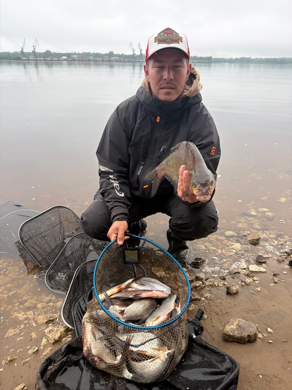 Angler catches fish in murky waters near Noviy, Russia