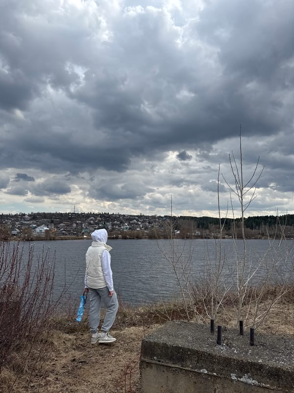 Residents enjoy waterfront walks in overcast Chaikovsky, Russia