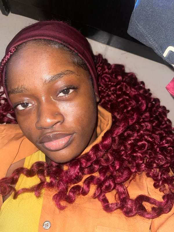 Portrait in burgundy headwrap, Ado Nigeria