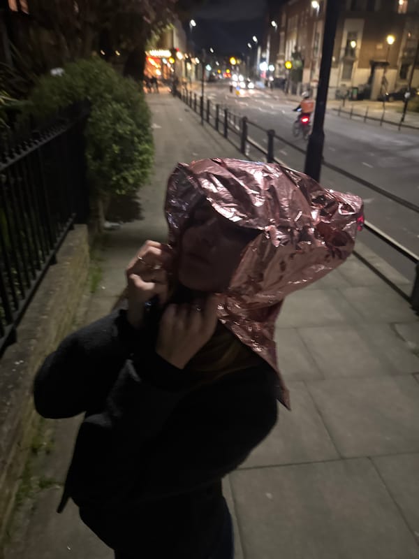 Person spotted wearing metallic hood on London street at night