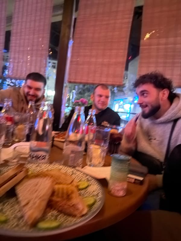 Three men dine together at restaurant in Chirpan