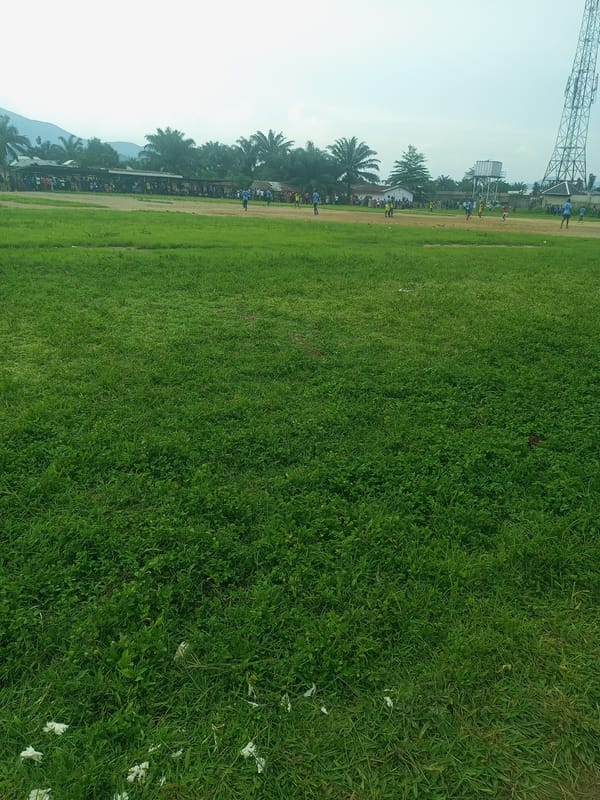 Afternoon soccer match on a grass field in Serti, Nigeria
