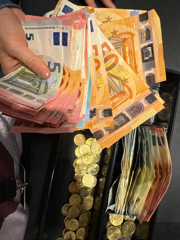 Person handles large amounts of Euro currency from register