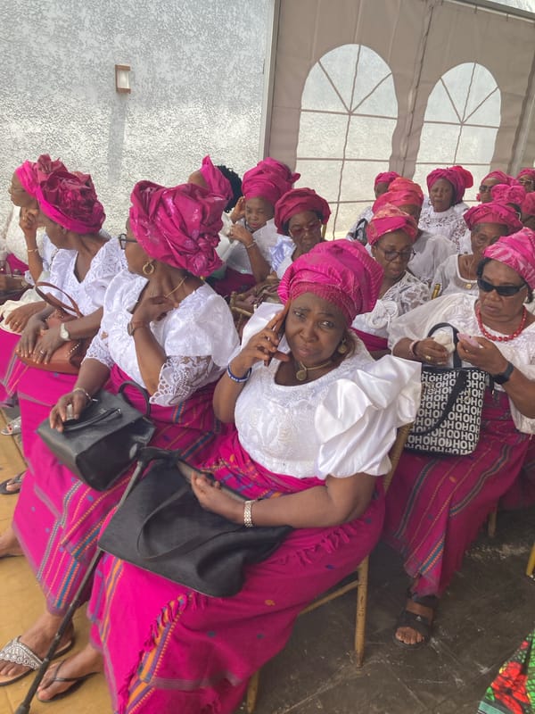 Women in matching pink attire gather for celebration in Nigeria