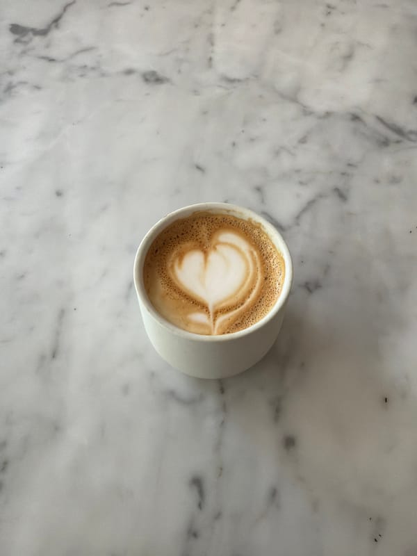 Heart-shaped latte art photographed in Los Angeles coffee cup