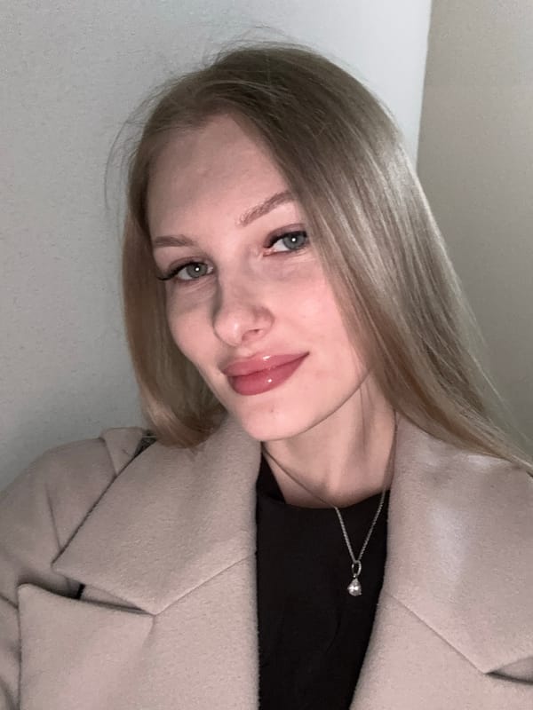 Woman applies lip gloss, takes selfies in Perm