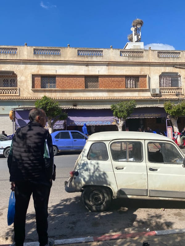 Street scene with van and car observed in Ben Freha, Algeria