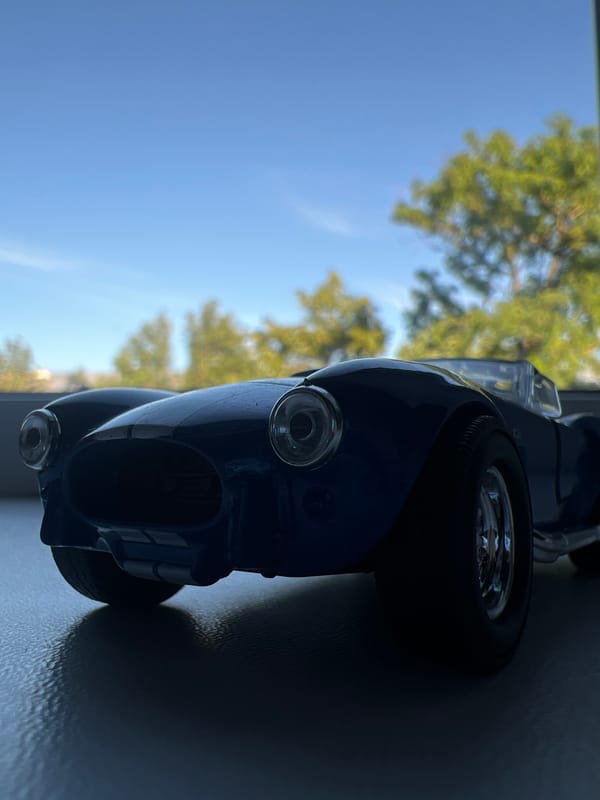 Close-up macro shots of a Tissot PRX watch and toy car