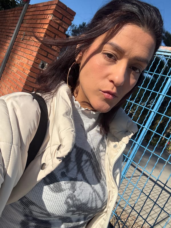 Woman takes morning selfie in Barcelona wearing puffer jacket