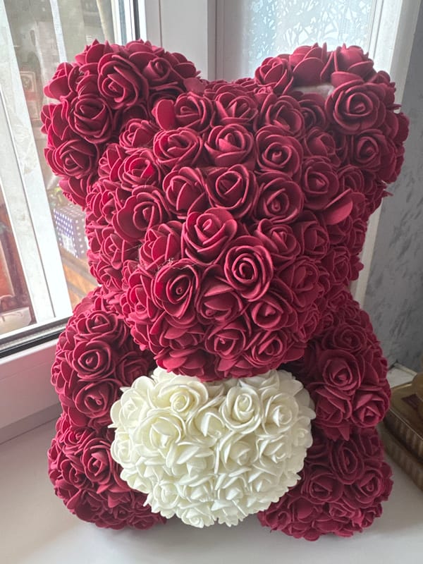 Artificial rose arrangements and a glimpse of natural foliage