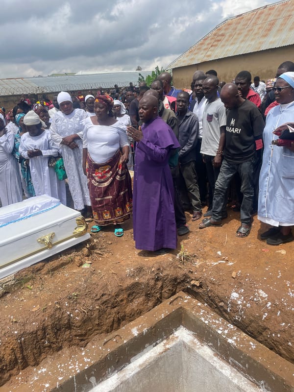 Burial ceremony underway at a graveside in Gura Top, Nigeria