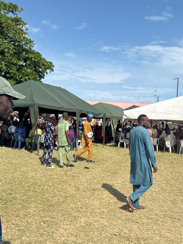 Public gathering with tents and flags held in Badagry