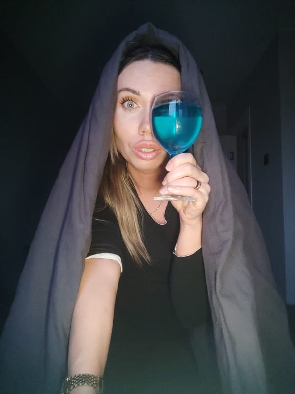 Woman poses with blue drink in Votkinsk apartment