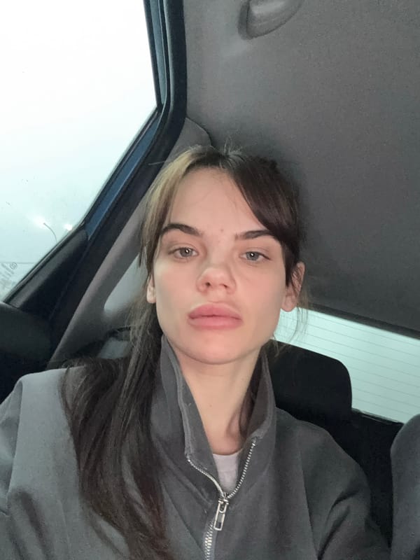 Woman takes car selfie in overcast Камышеваха morning