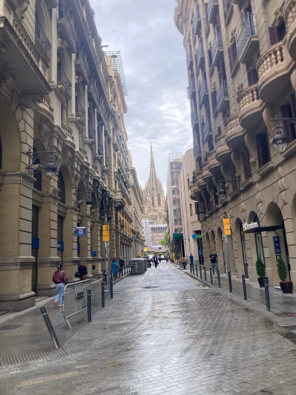 Wet streets and classical architecture observed in Barcelona