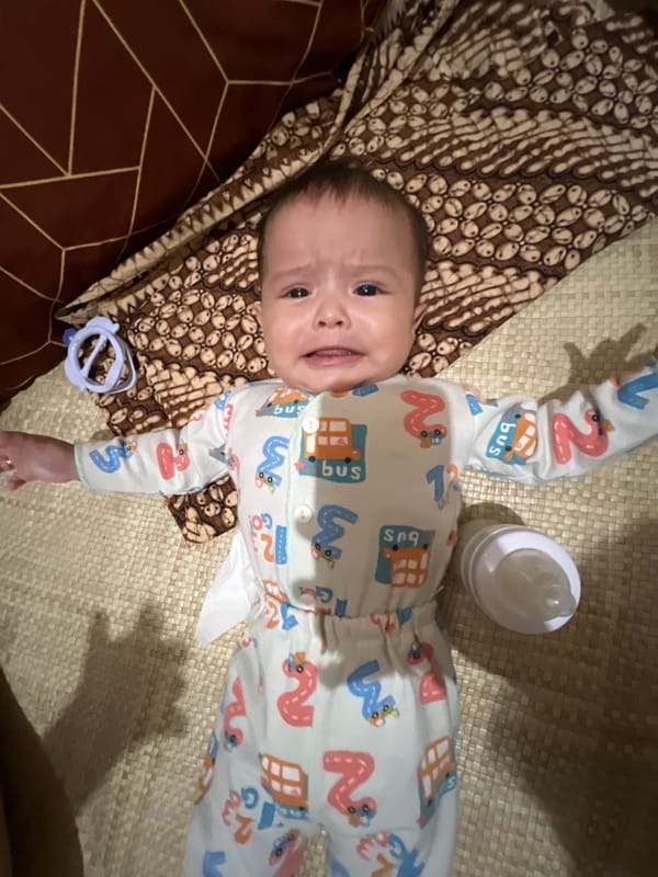 Baby on a mat in Lhokseumawe, moments apart
