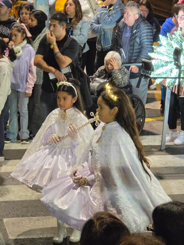 Festive night parade in Iquique, Chile, with ornate traditional dress