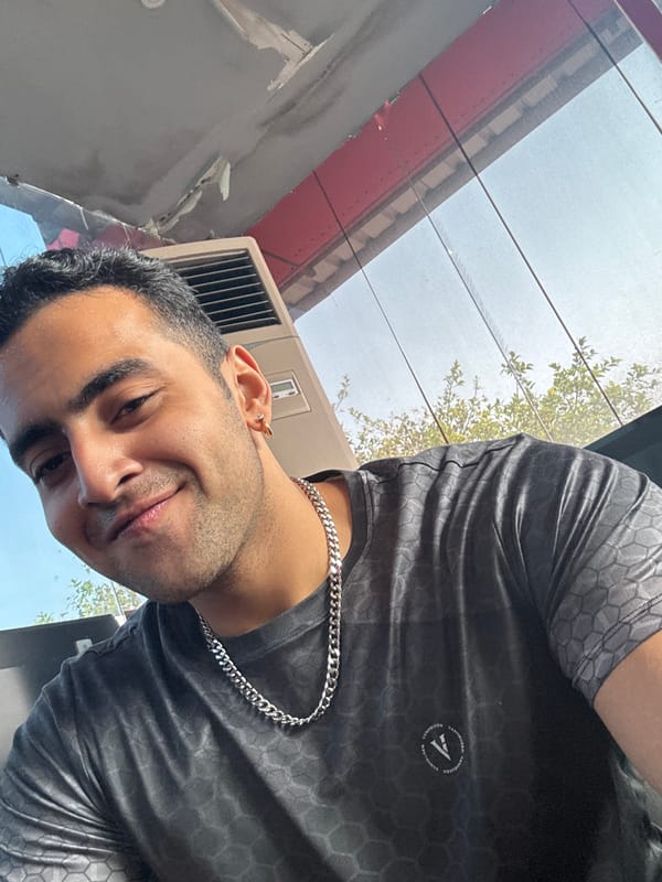 Man poses for photos outside modern building in Kolkata