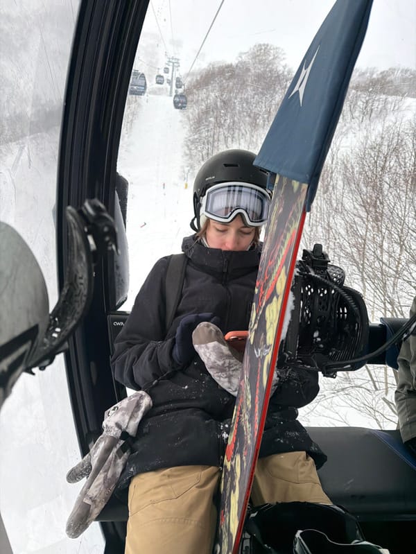 Snowboarder rides morning lift in Kutchan, Japan