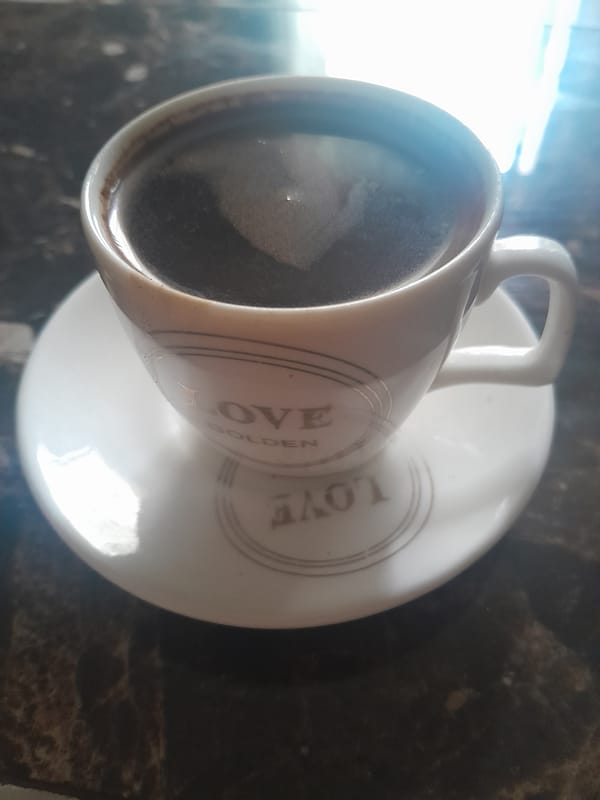 Patterned coffee cup observed on saucer early morning