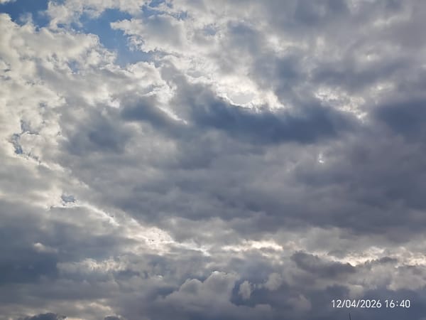 Cloudy skies with blue patches documented April 12