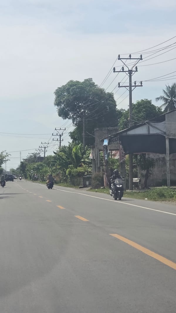 Morning traffic flows on main road in Teungoh Baro