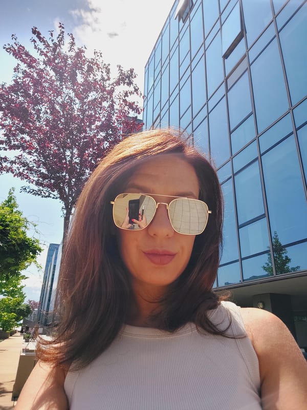 Selfies and architecture outside a glass building in Sofia