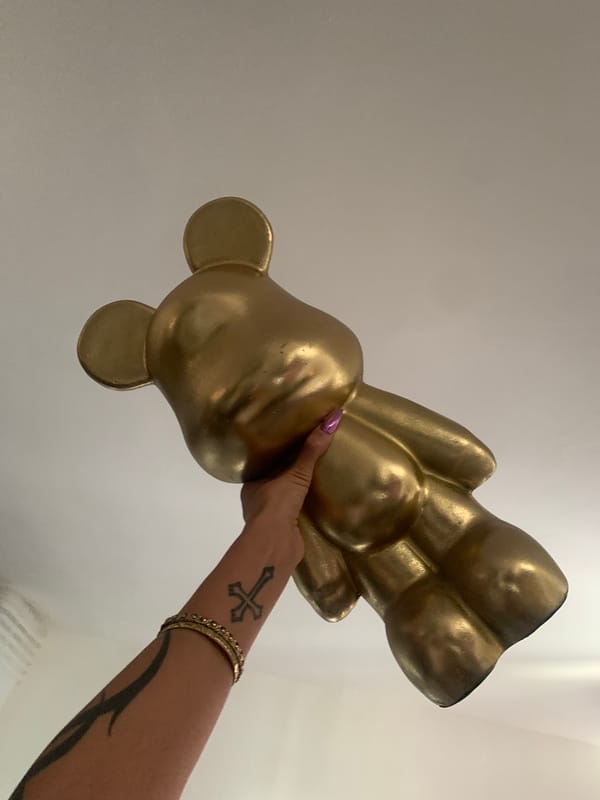 Person photographs objects including sculpture, plush toy in London