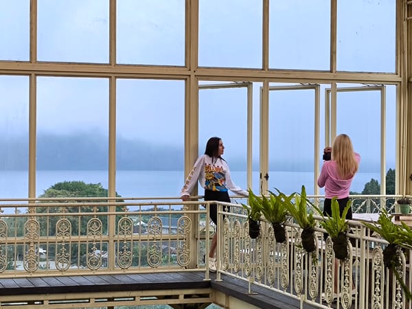 Two women tour greenhouse facility in Candikuning, Indonesia