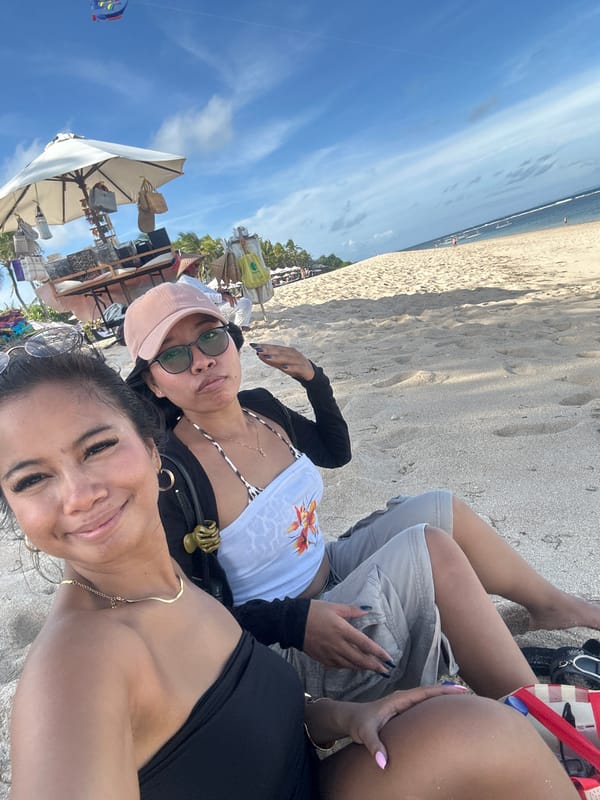 Two women enjoy sunny morning at Kuta Selatan beach
