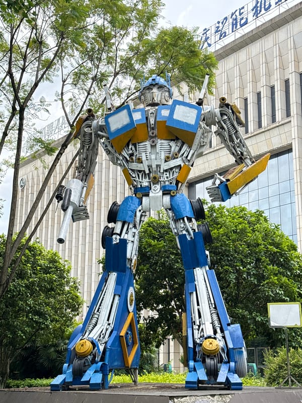 Morning street life captured around robot sculpture in Chinese city